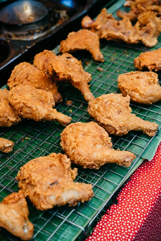 closeup of fried chicken on cooling rack
