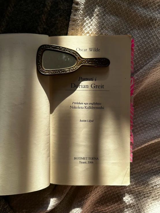 an open book with a small spoon stuck into it