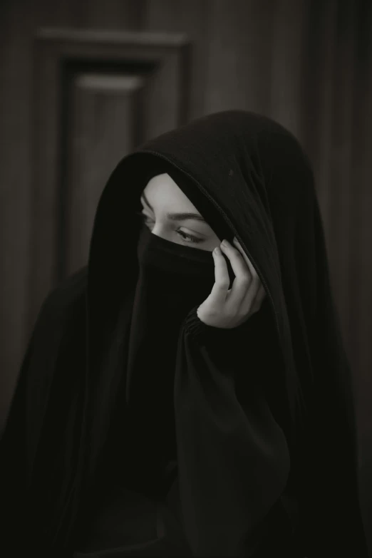 a woman with dark clothes talking on the phone