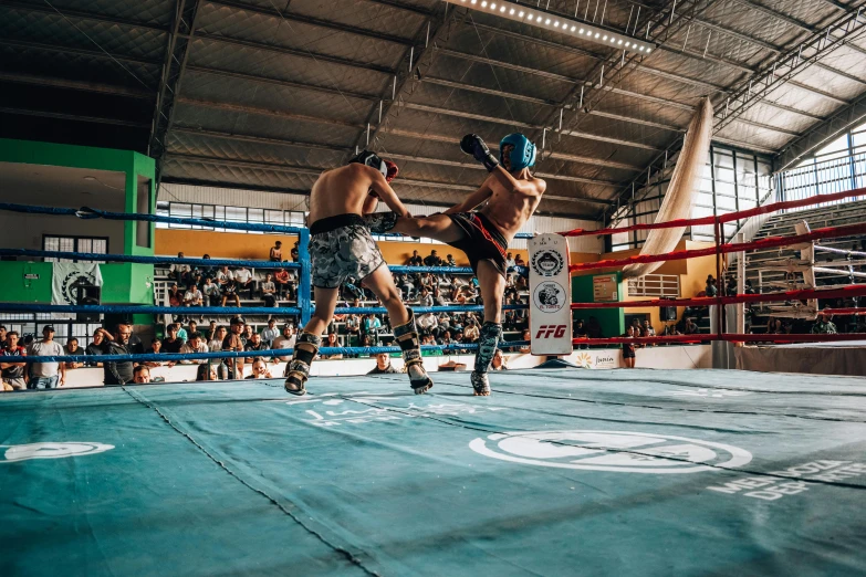 two men practicing kickbox moves at the gym