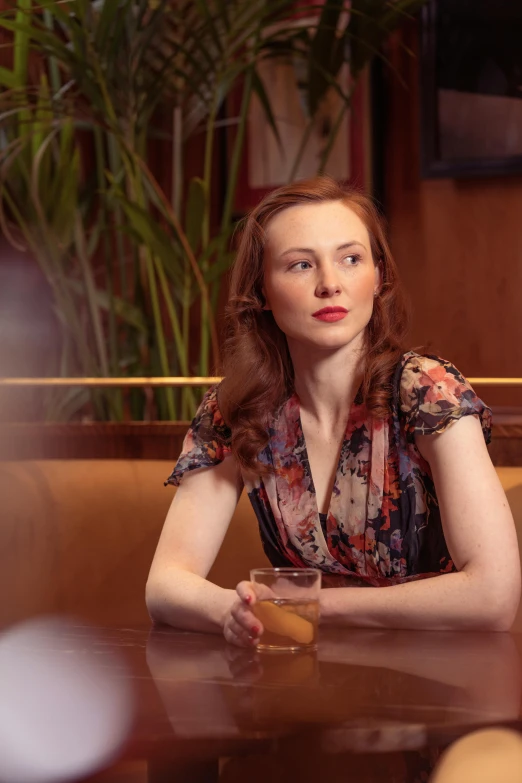 a woman sitting at a table in a cafe