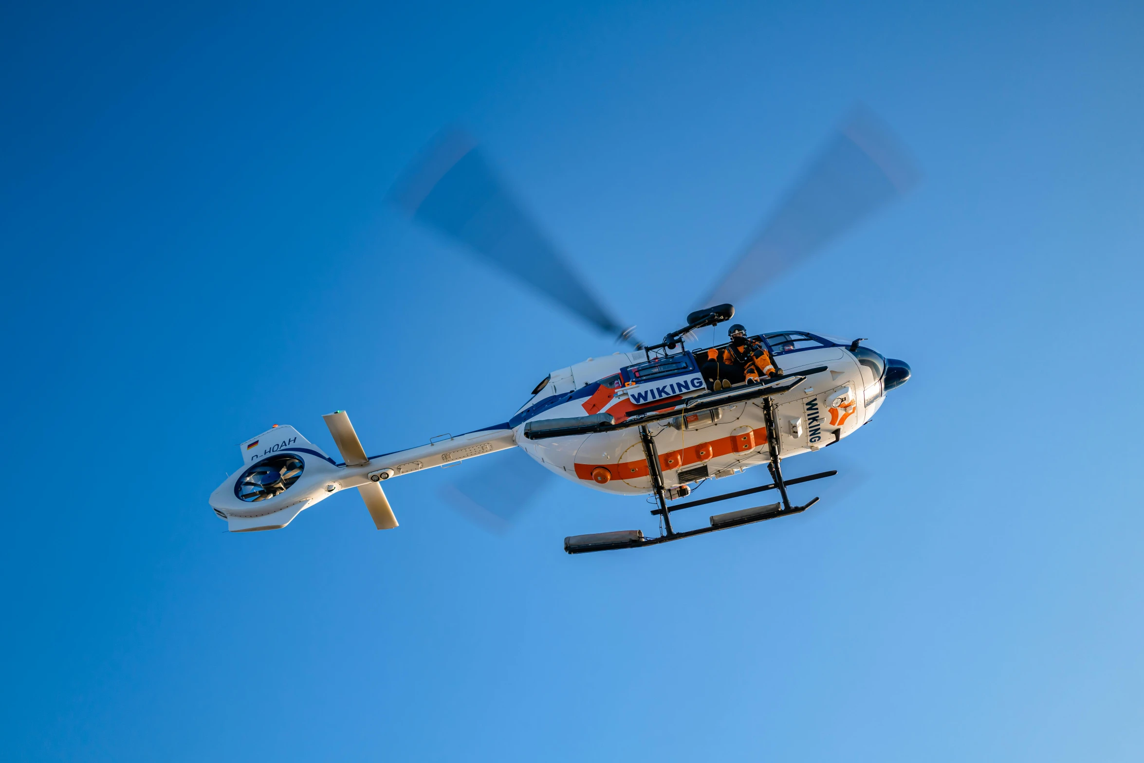 a helicopter with its propeller lifted high into the air