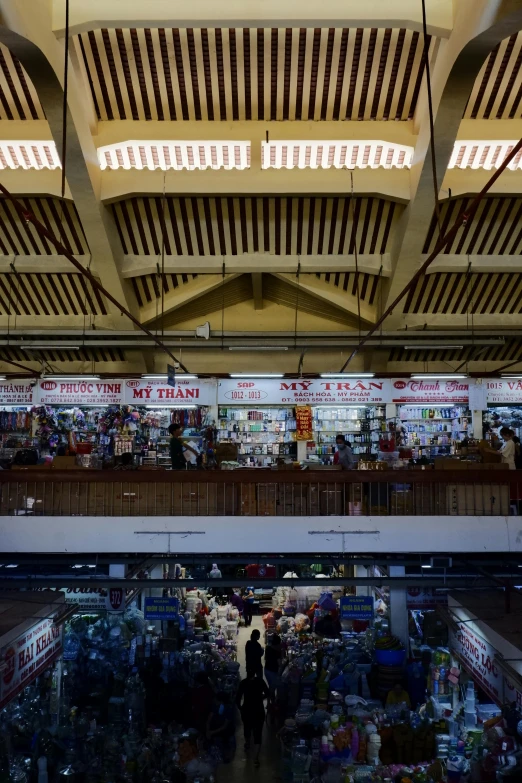 two people stand in a large, crowded building that has many open areas to store