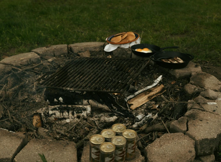  dogs and buns cooking on a grill outdoors