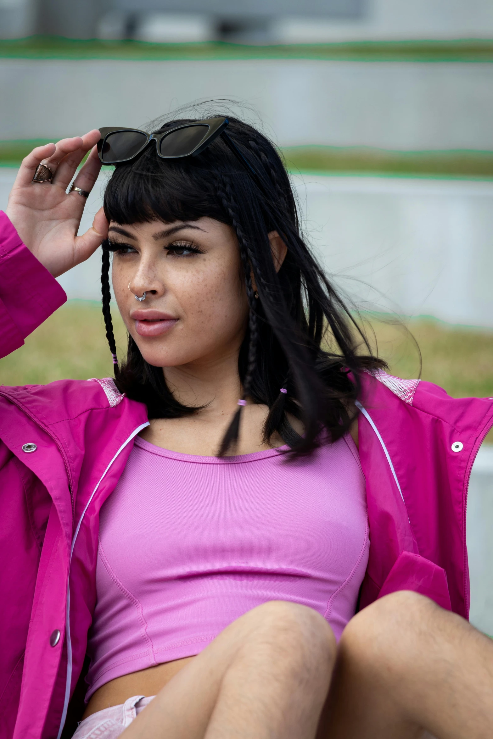 a young woman wearing a pink top and a purple jacket