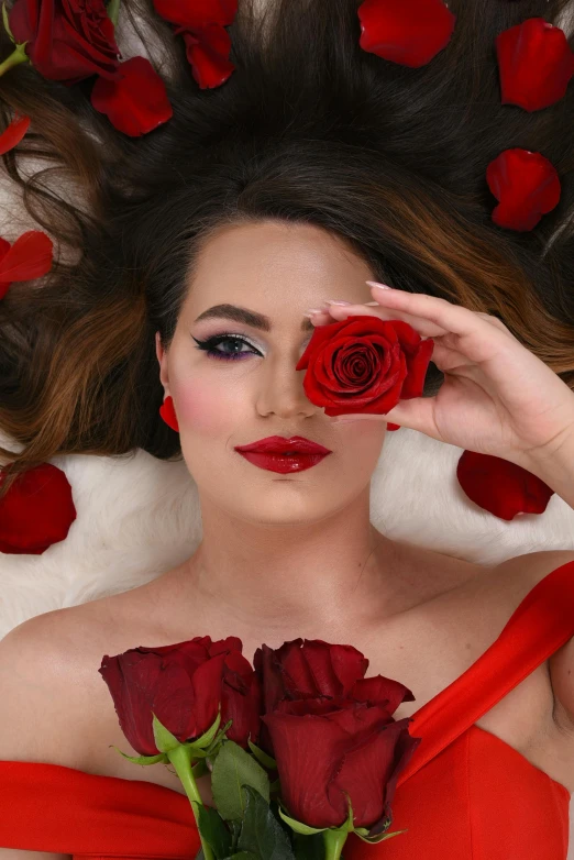 woman with roses covering her face with hand