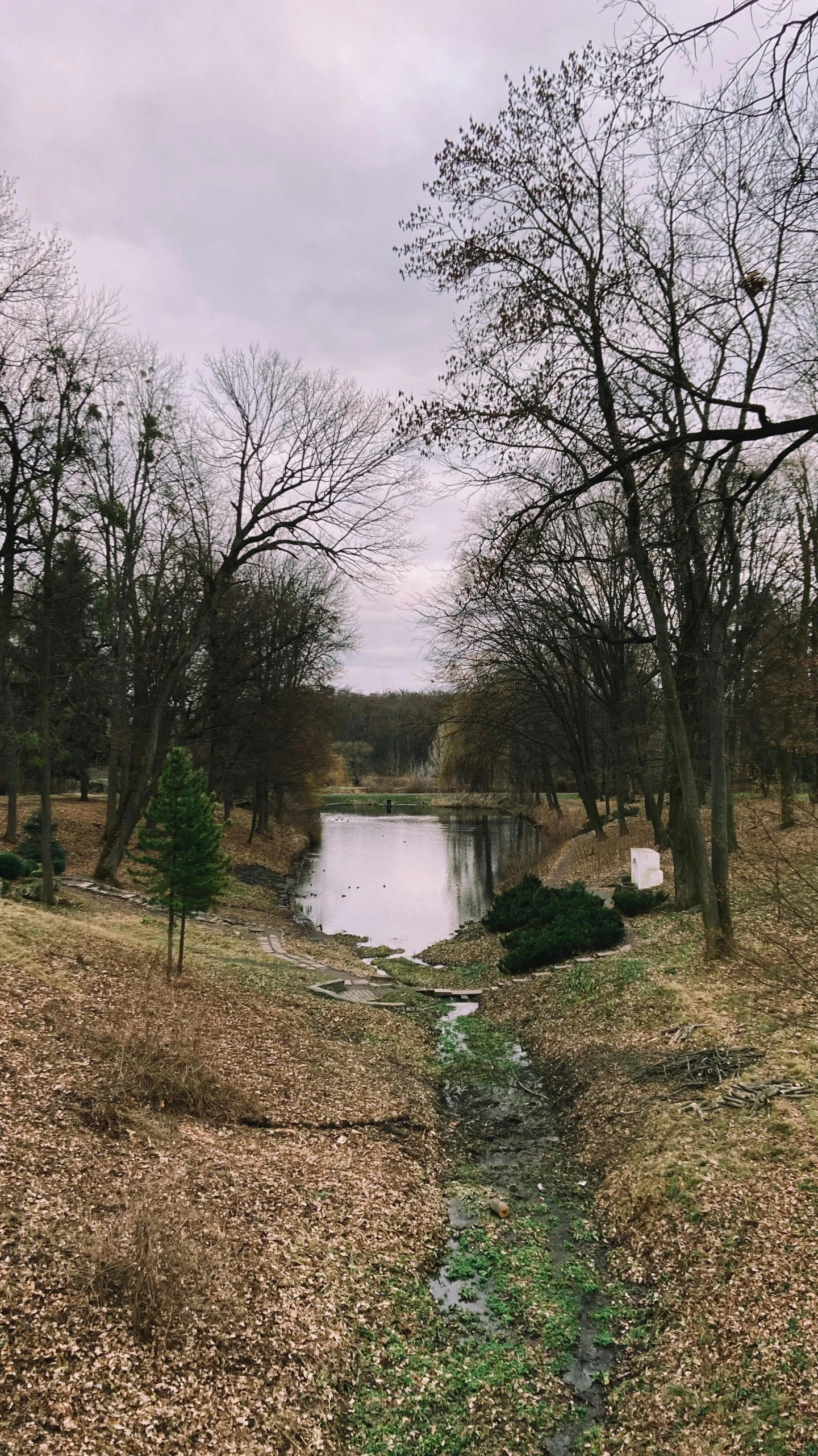 a small river is seen in a bare landscape