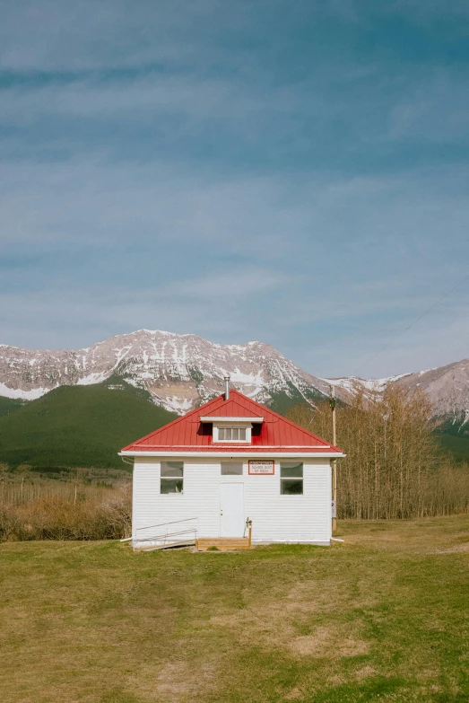 white building on the side of a mountain range