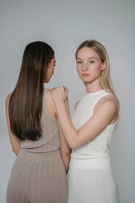 two beautiful women pose for the camera