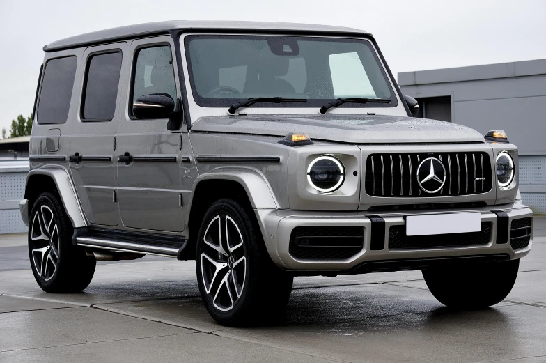 the front end of a silver mercedes benz suv