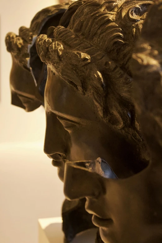 a close up of a sculpture of three faces