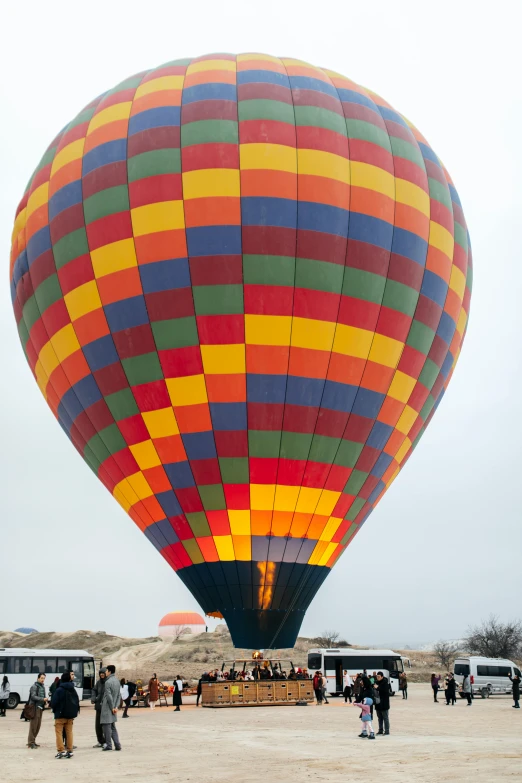 a large  air balloon sitting on top of a sandy beach