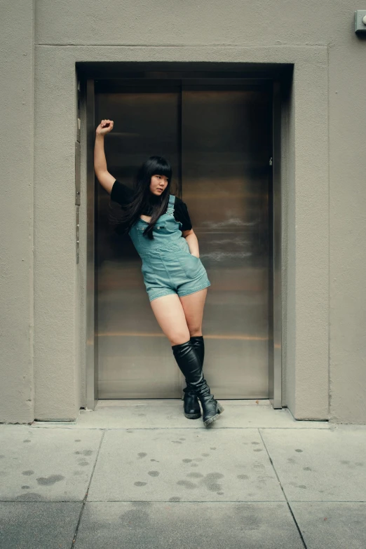 a woman wearing a skirt, boots and a hat