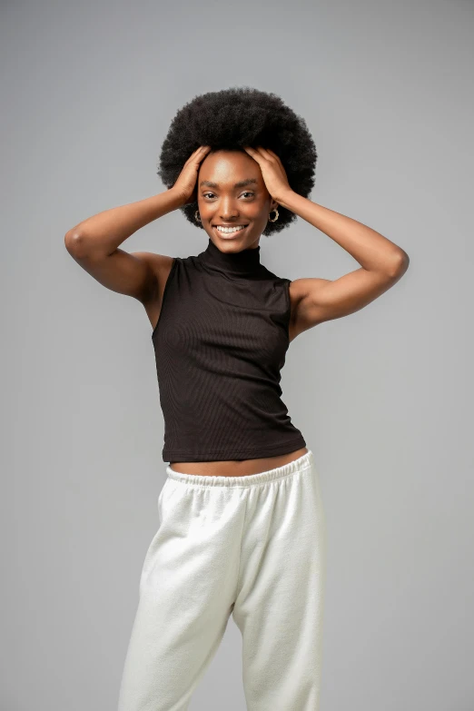 an african american woman smiling and covering her ears