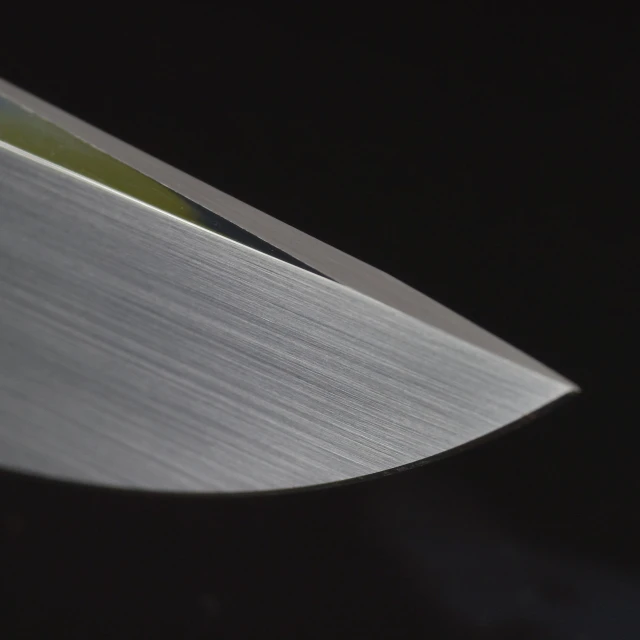 a large sharp knife laying down on a table