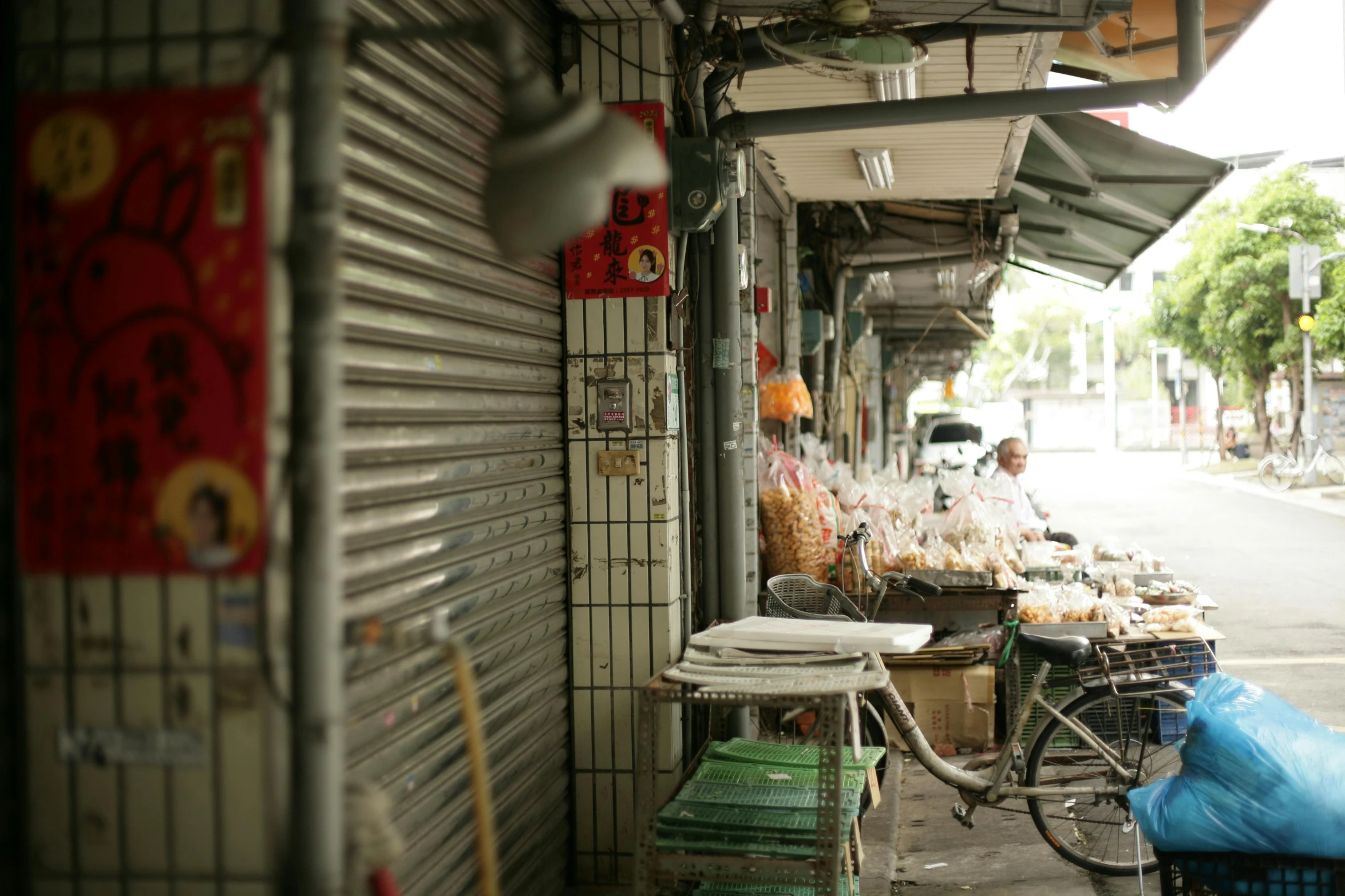 a bicycle parked next to a sidewalk market