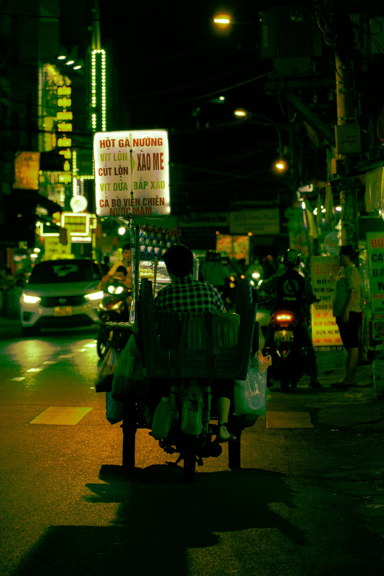 a man is driving a small bike down the street