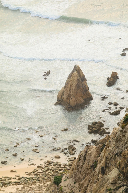 a person walking on a trail overlooking an ocean