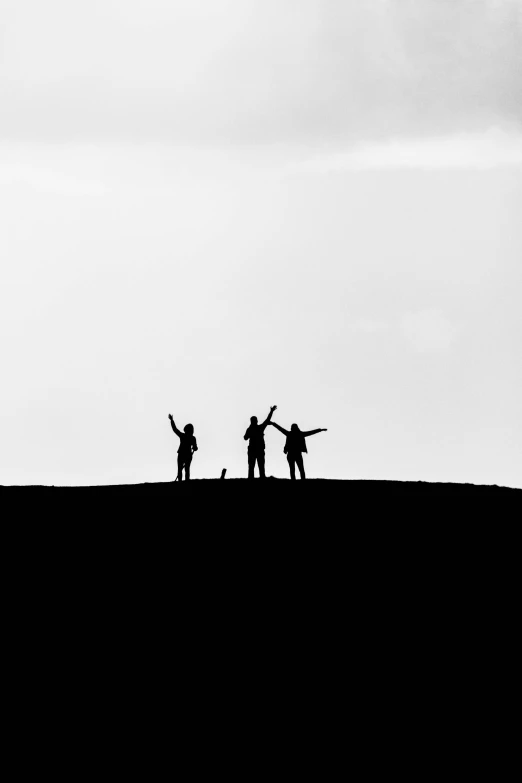 a group of people standing on top of a hill