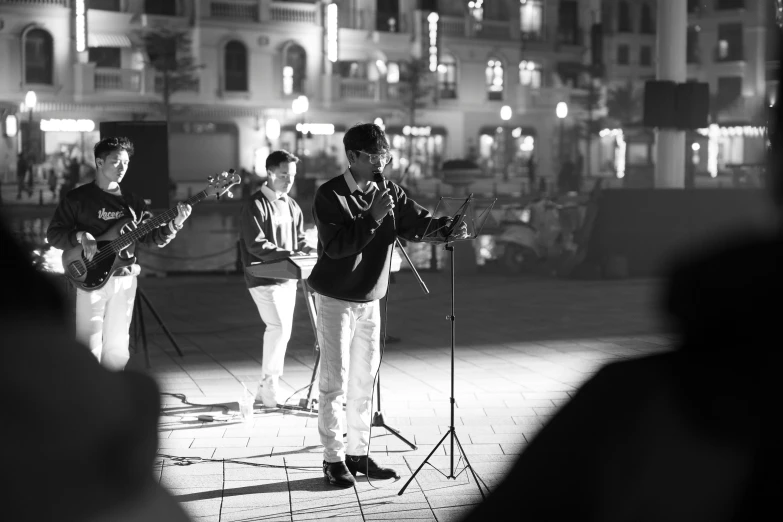 the group of people are standing around with instruments