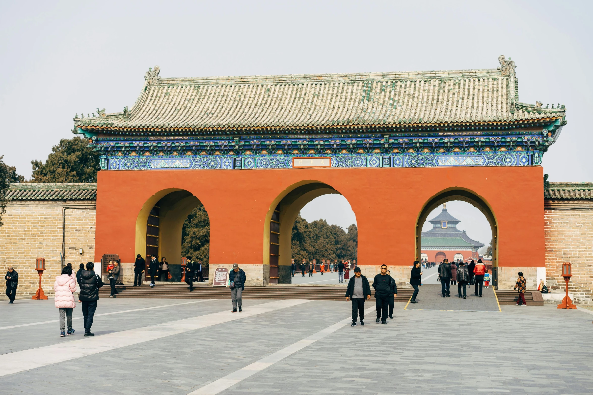 many people are walking outside an oriental building