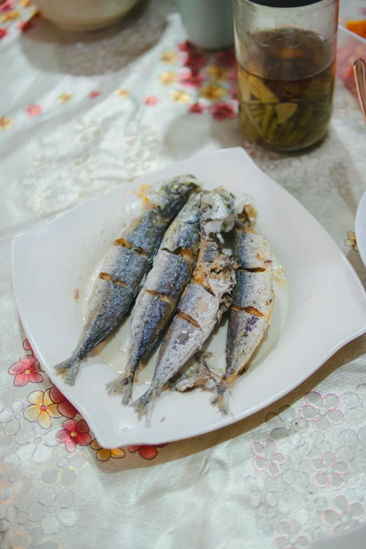 there is a plate with fish on it and some other foods