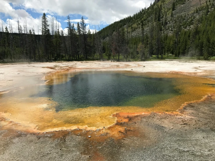 a blue pool is surrounded by large brown pools