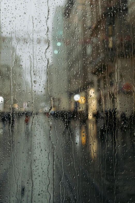 city street covered in rain from inside an umbrella