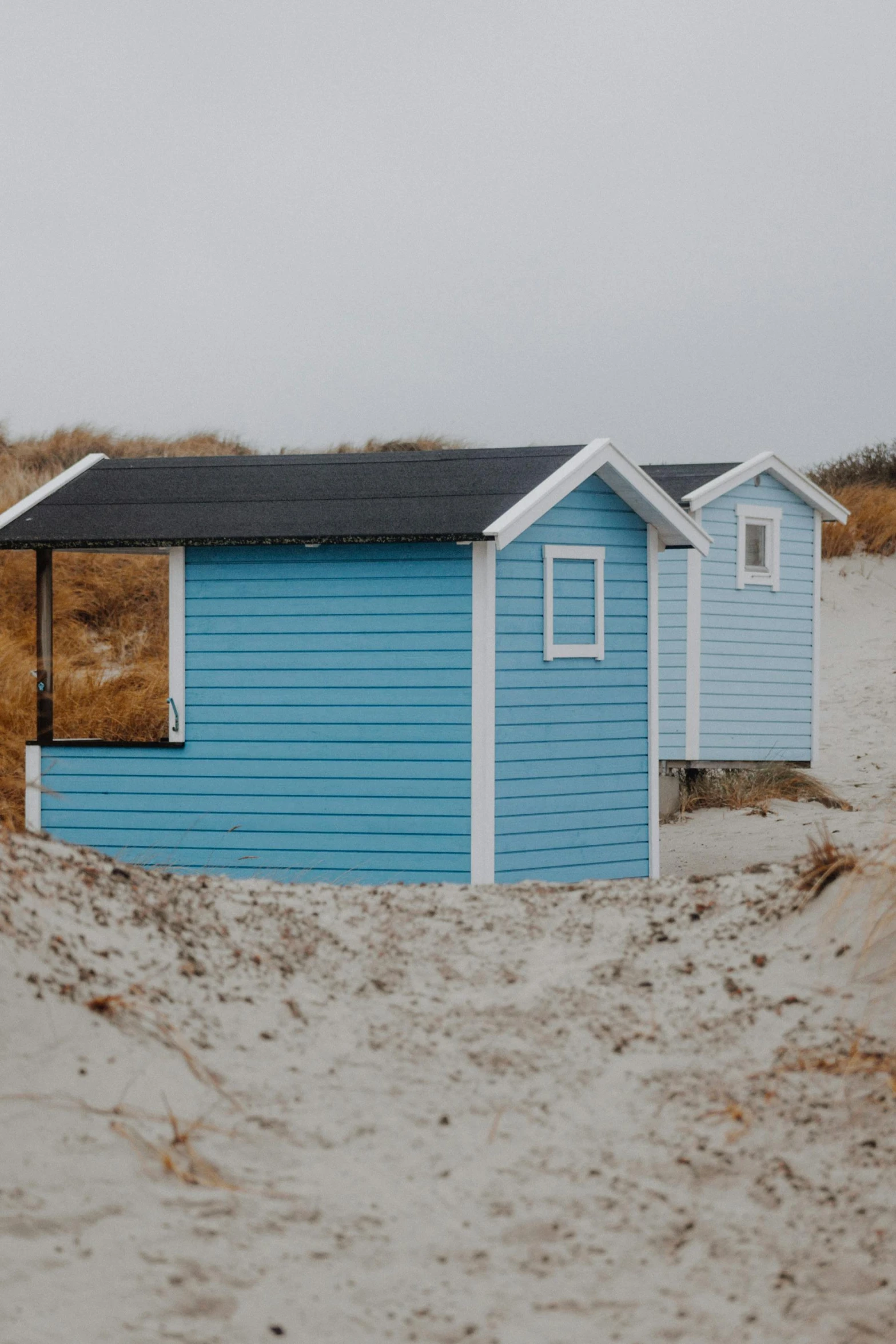 a few sheds with doors at the beach