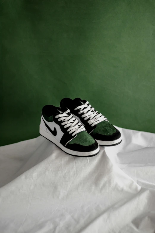 two shoes on top of a green background