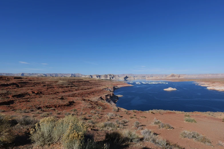 a group of small boats in a lake in the desert