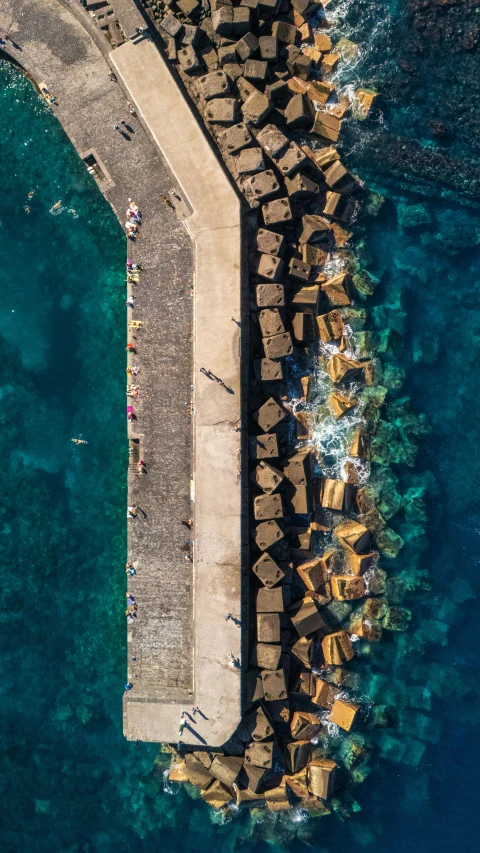 an aerial view of the shoreline, with umbrellas on it