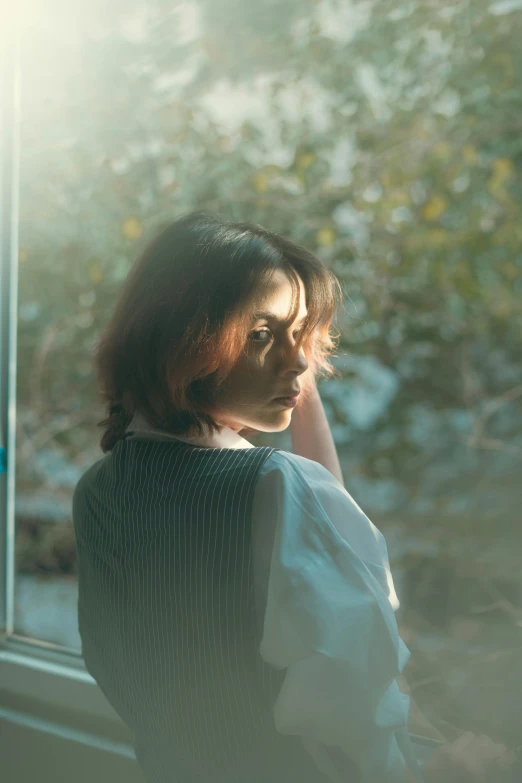 a  looking out a window on a sunny day