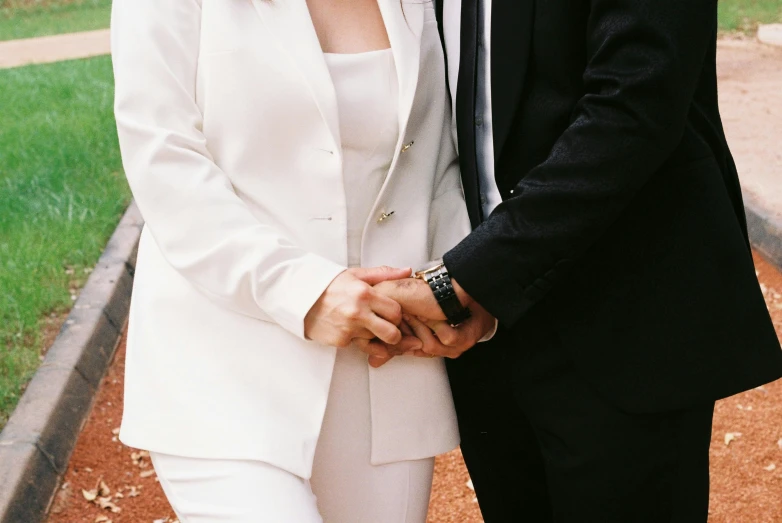 a young man and woman in business attire posing together