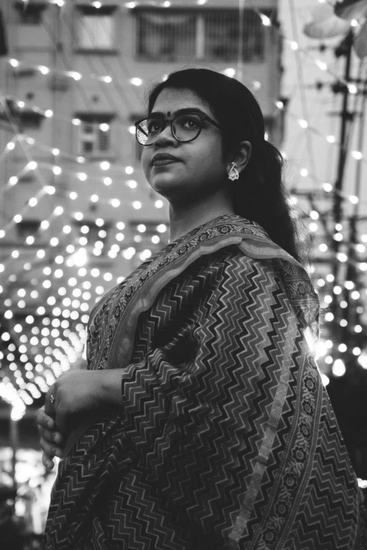 black and white pograph of woman standing in front of buildings