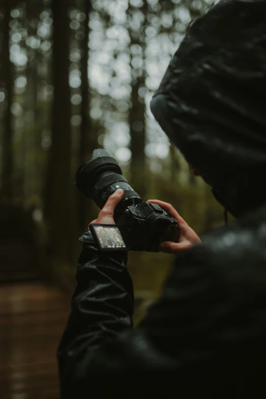 someone taking pictures through their smartphone in the rain