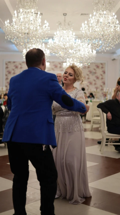 a couple standing next to each other in a hall