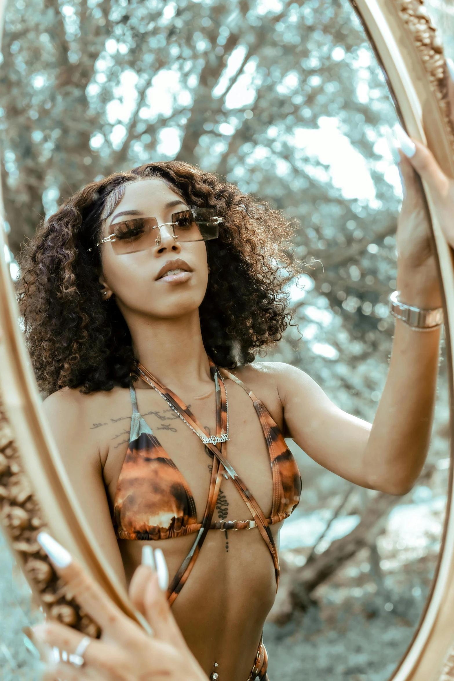 a woman is wearing a bikini and is looking at her self in the mirror