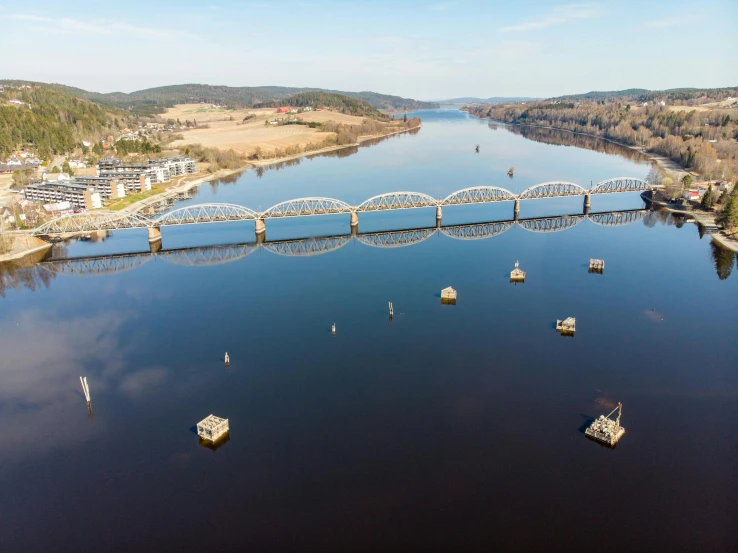 a wide bridge spanning a large river between two towns