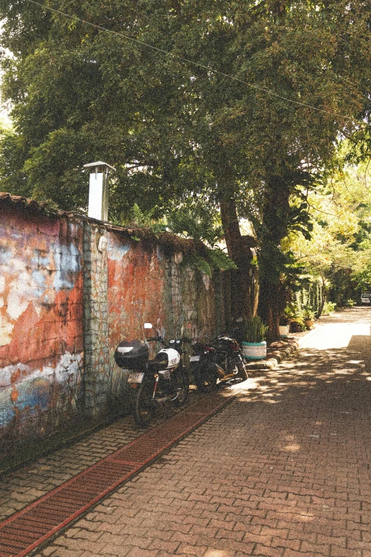 several bikes are parked in front of a wall