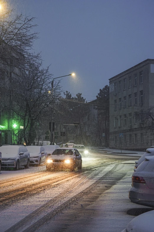 a street filled with lots of traffic and covered in snow