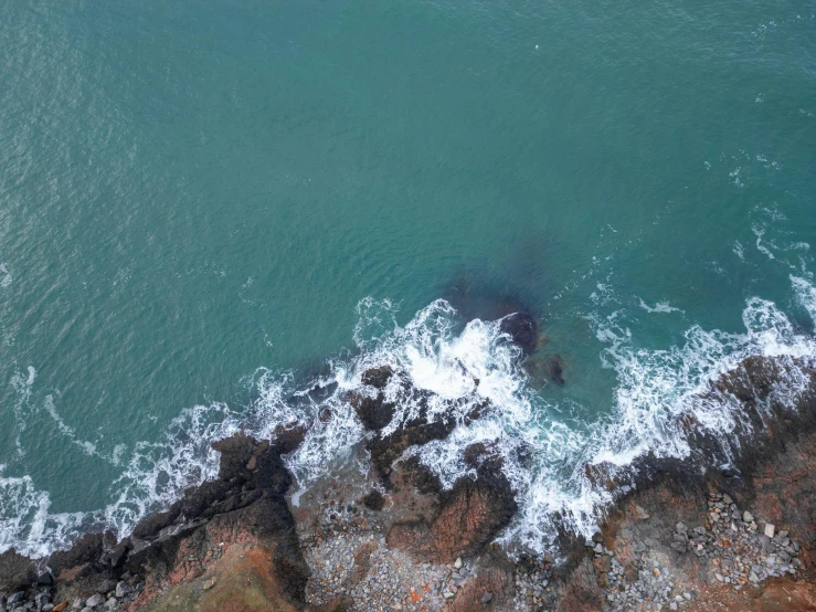 an aerial view of a ocean with small waves