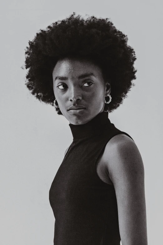 a beautiful young lady with an afro standing