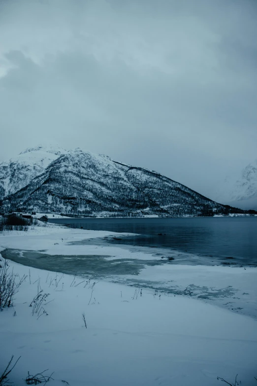 a lake surrounded by mountains in the background