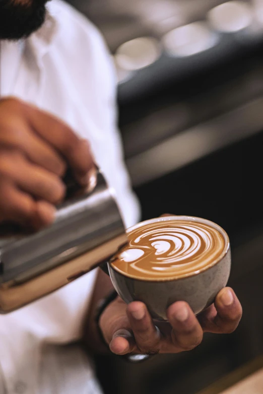 the coffee has been placed in the cup with an artistic look