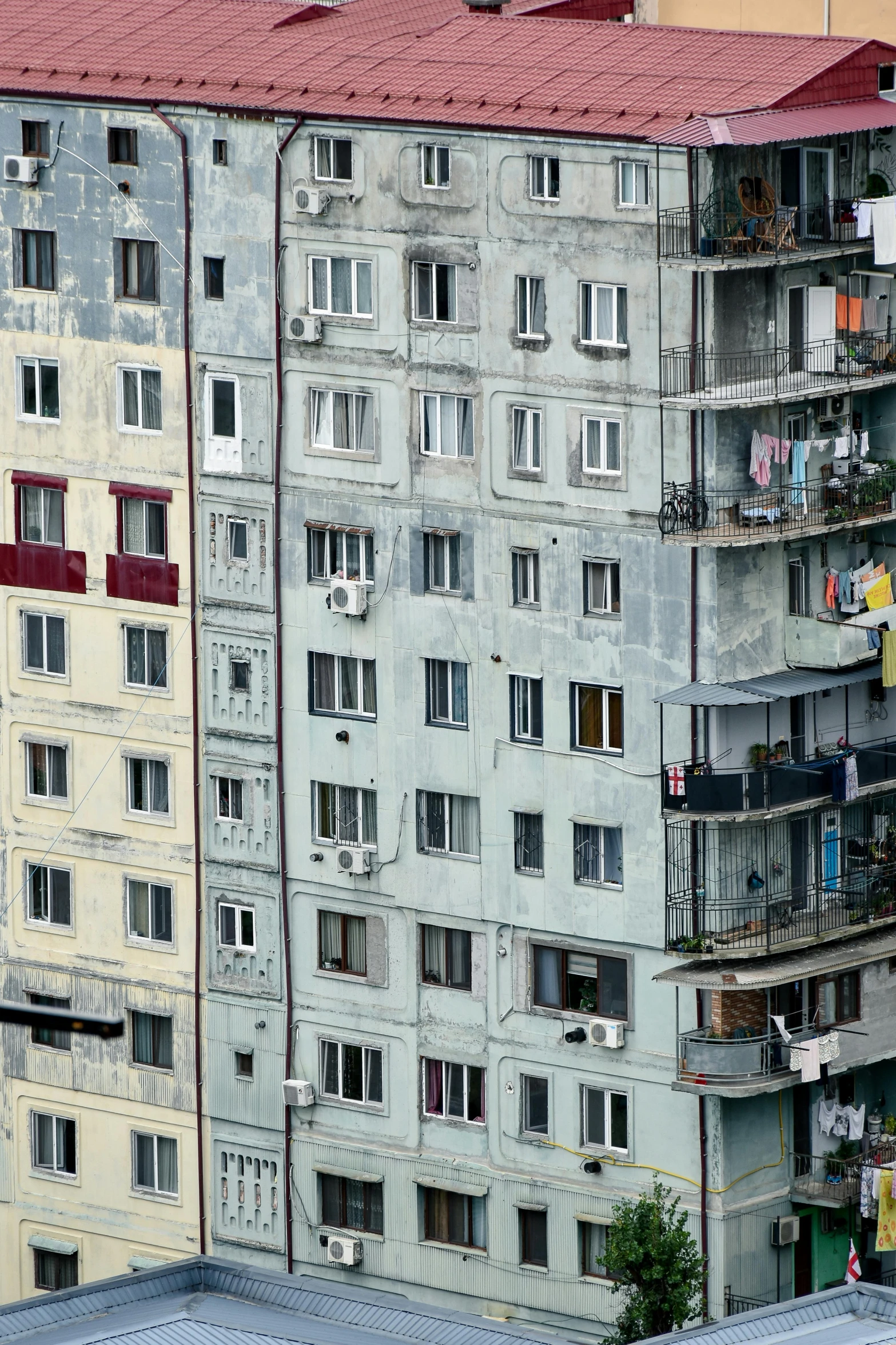 two large buildings with balconies and windows on top