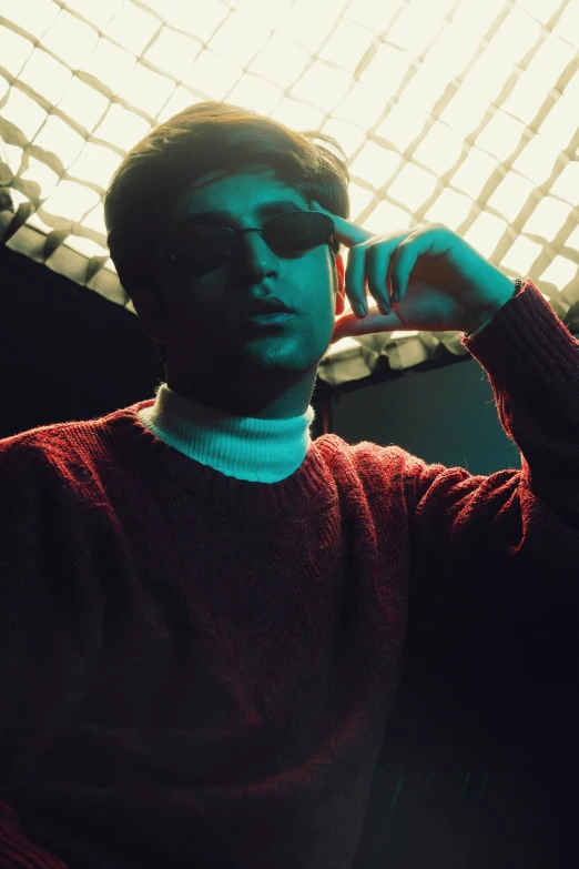 a young man in red sweater and light colored background