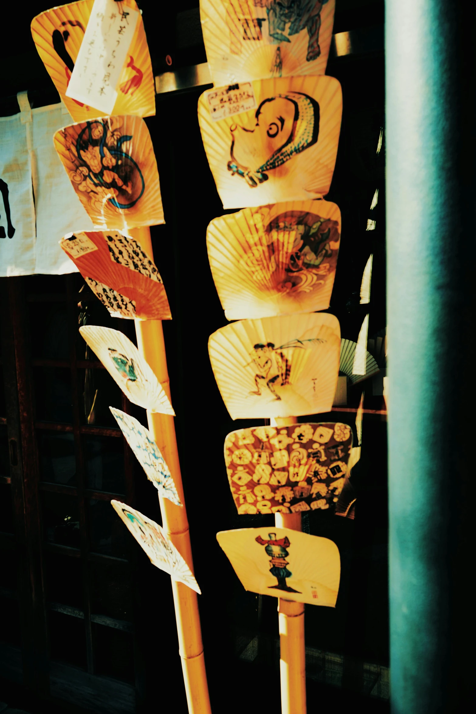 different colored japanese paper fans and papers in display