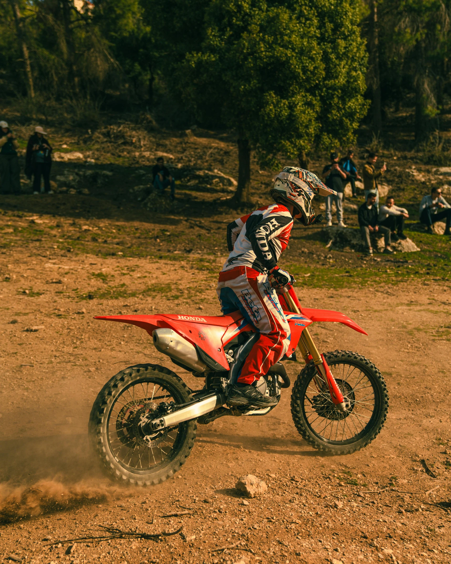 a motorcyclist is riding in dirt on his bike