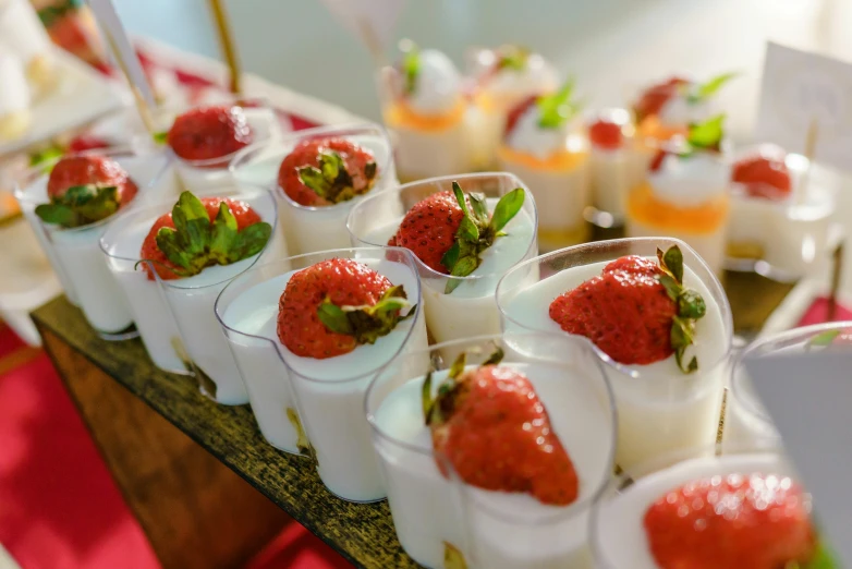 several cups with various sized desserts sitting on a tray